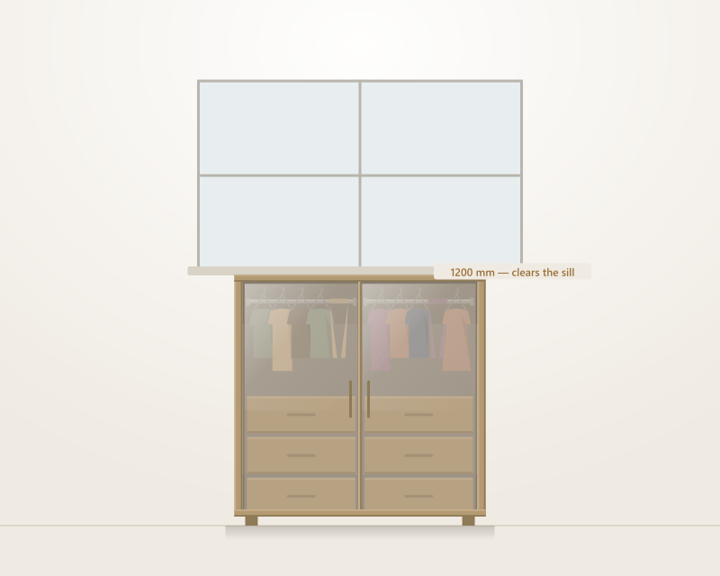 A waist-height Alucent armoire drawn beneath a window, with a lamp and a tray on its top surface and drawers open below